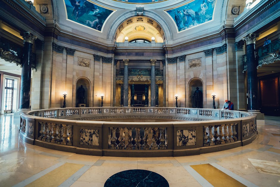A stunning view of a grand museum hall with ornate columns and beautiful ceiling art.